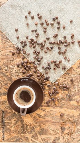 Βrown Coffee cup. Greek coffee on wooden background. Turkish coffee and beans. © Artem