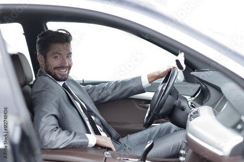 Handsome businessman in the drivers seat in his car © ASDF