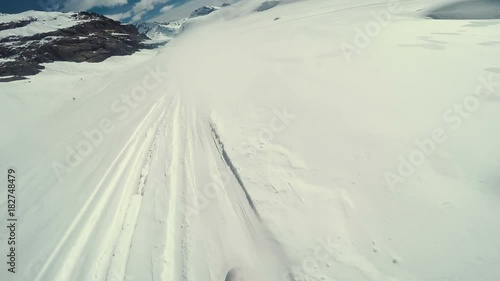 Point of view shot of Actionsportlers snowboarder while freeride in remote area in Europe Alpes photo