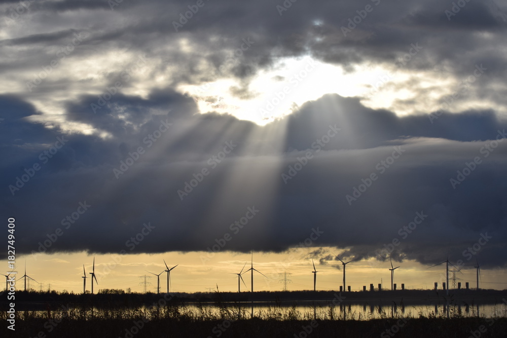 Landscape with windmills and sun beams on autumn day Landscape with windmills and sun beams on autumn day