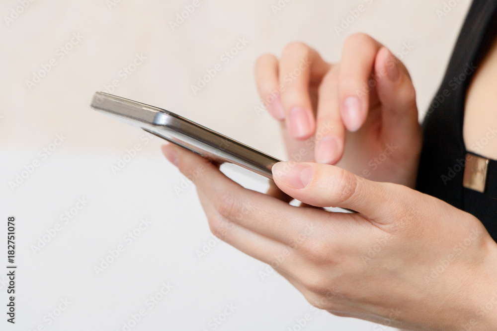 A young girl is holding smartphone. A young girl is holding smartphone.