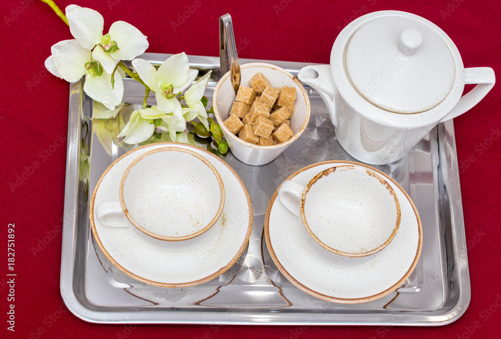 Two white mugs on a tray white bed, breakfast concept Two white mugs on a tray white bed, breakfast concept