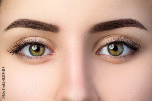 Close up view of beautiful brown female eyes