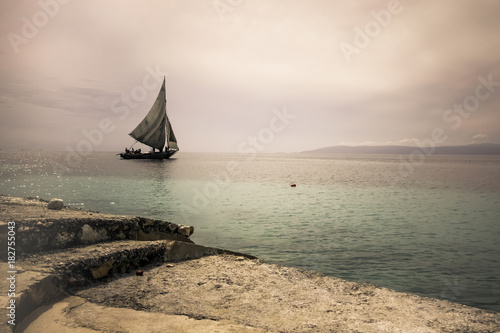 Obraz na plátne A sailboat in the distance off the coast of Haiti