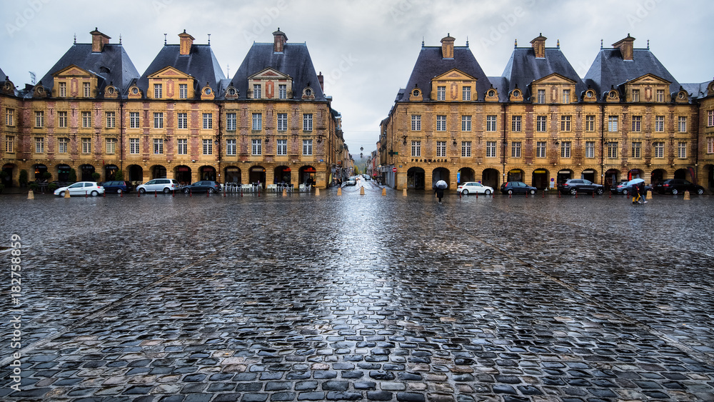 Warm yellow place Ducale buildings under rain in Charleville-Mezieres, France