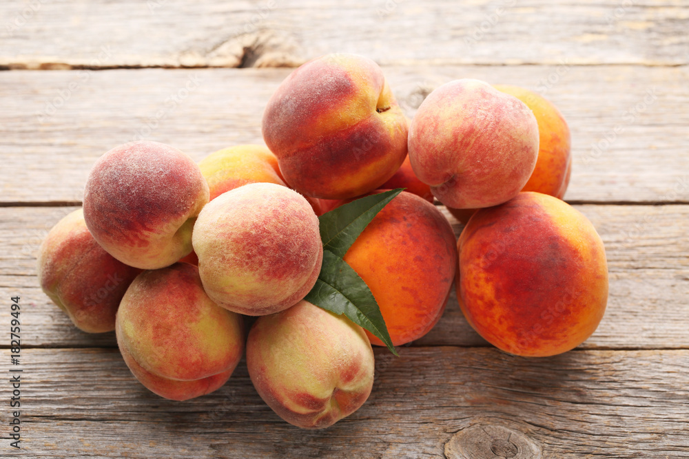 Ripe peaches fruit on grey wooden table Ripe peaches fruit on grey wooden table