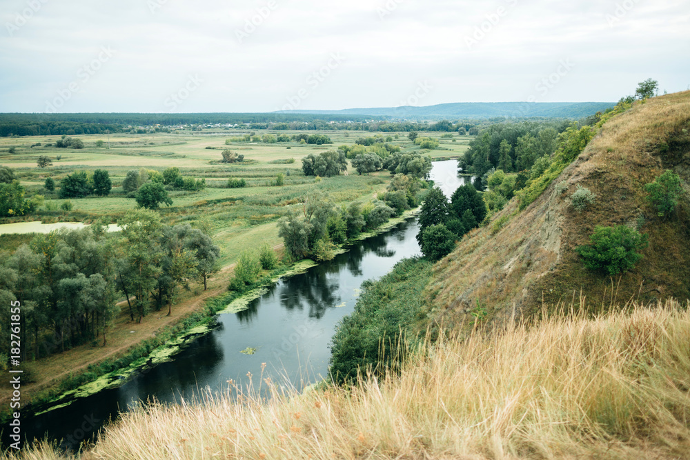 beautiful view from the hill to a picturesque valley with a river. beautiful view from the hill to a picturesque valley with a river.