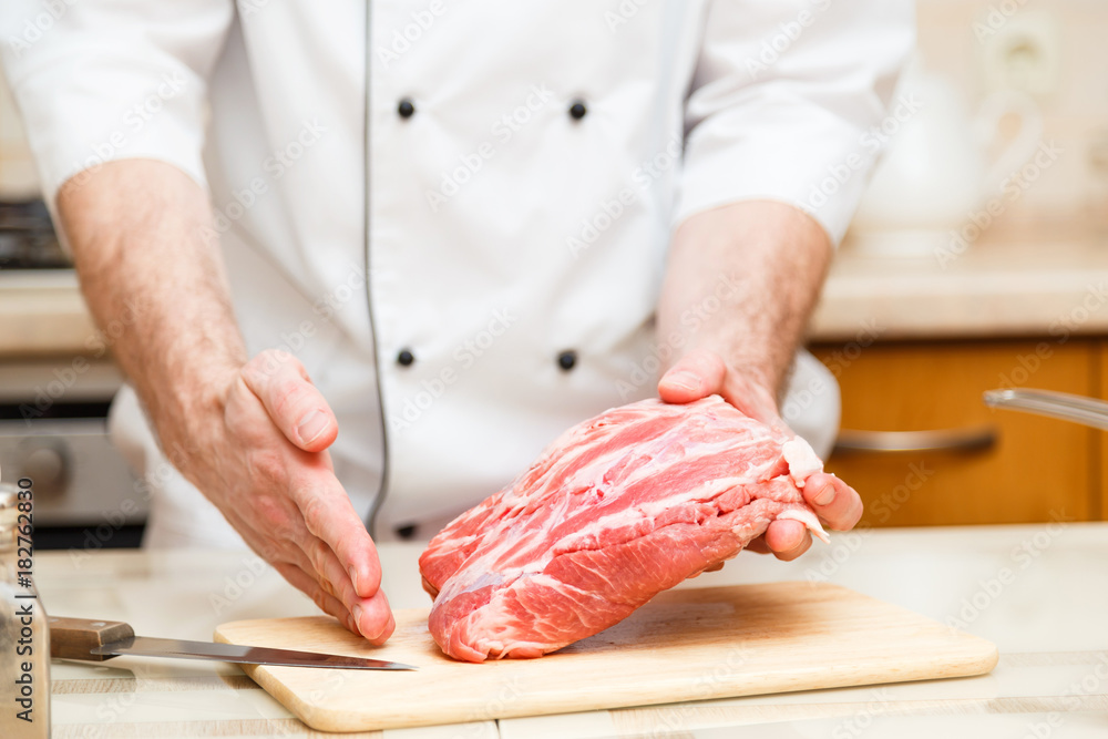 Cook men show how cuts a piece of meat. Close up Cook men show how cuts a piece of meat. Close up