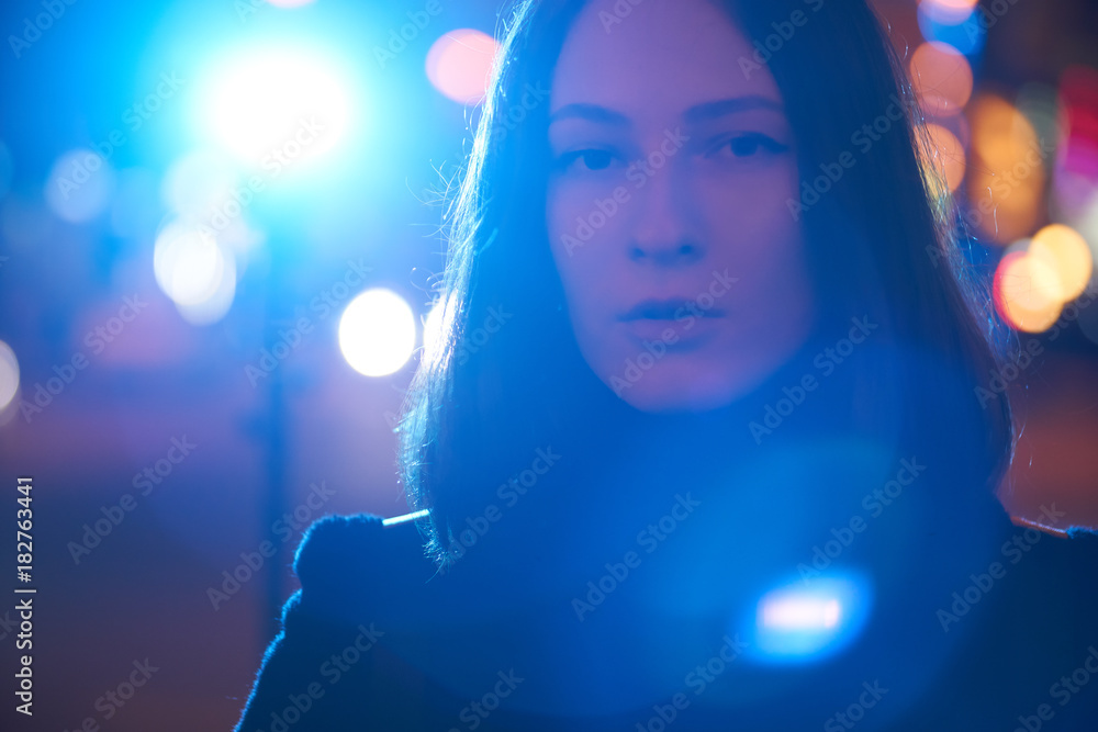 Portrait of a girl in a night city. night lights bokeh. Bright lantern on a background of blue color. Beauty Lifestyle Portrait of a girl in a night city. night lights bokeh. Bright lantern on a background of blue color. Beauty Lifestyle