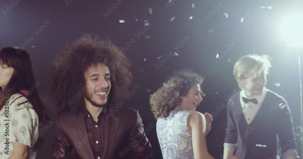 Nightlife concept, group of young beautiful men and women dancing. Cheerful friends on the dance pole in the club. Nightlife concept, group of young beautiful men and women dancing. Cheerful friends on the dance pole in the club.