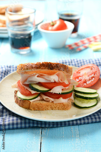 sandwich with roast turkey  cucumbers and tomato