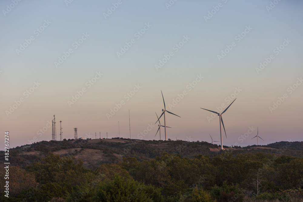 Wind turbines on a pink horizon at sunset Wind turbines on a pink horizon at sunset