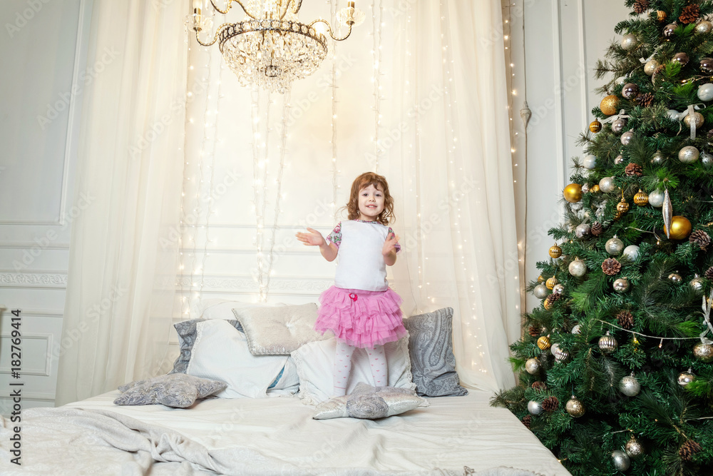 young girl near a Christmas tree young girl near a Christmas tree