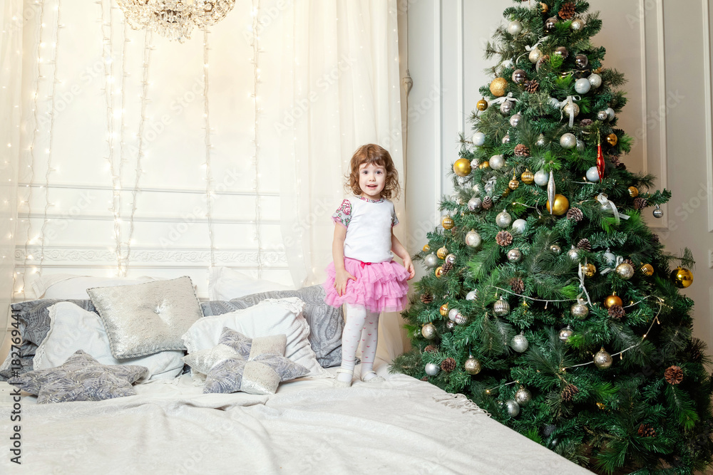 young girl near a Christmas tree