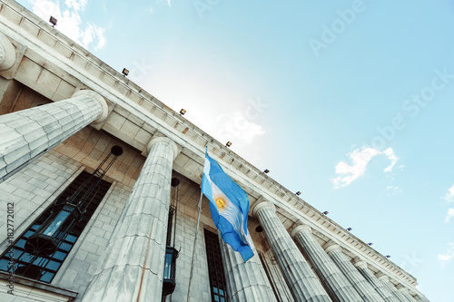 Classic building with columns and Argentine flag flaming © simonmayer