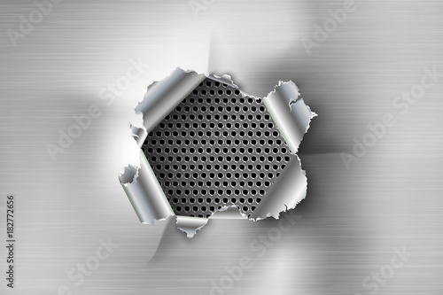 Hole torn in ripped steel on metal background