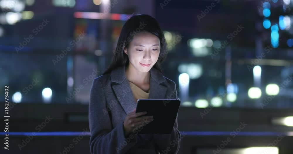Young Woman use of tablet computer at night Young Woman use of tablet computer at night