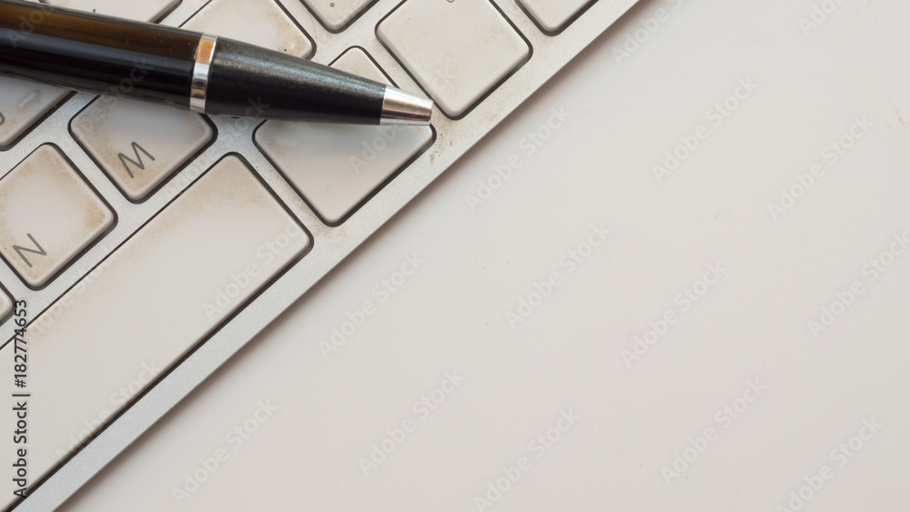 pen on keyboard white background pen on keyboard white background