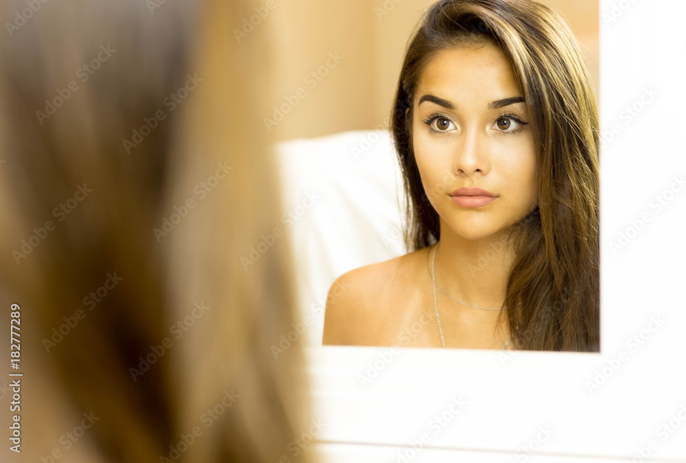 Reflective Portrait of young woman mixed race face in mirror Reflective Portrait of young woman mixed race face in mirror