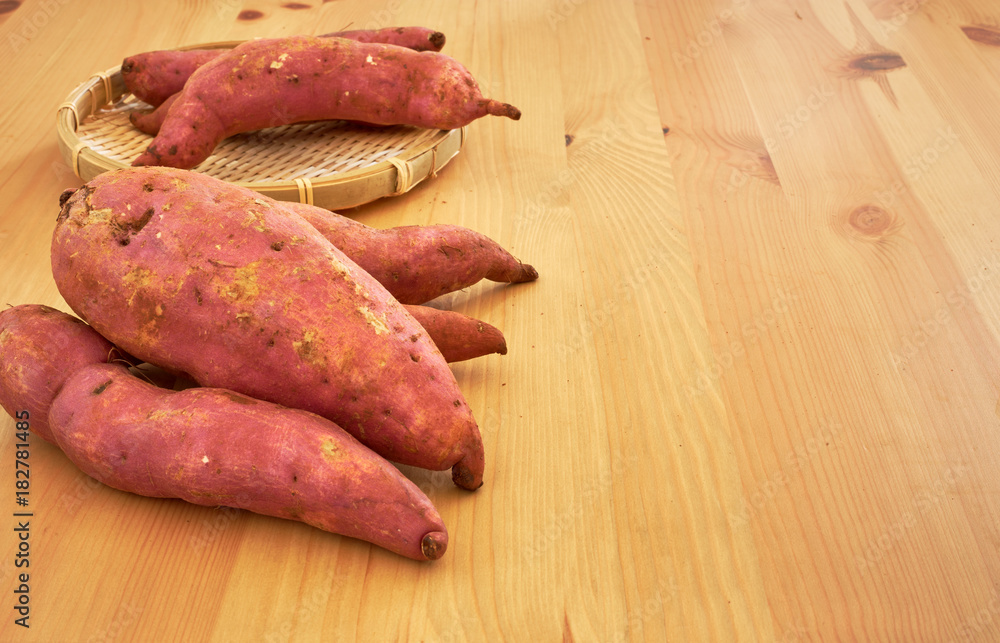 Sweet potatoes on a rustic wooden table Sweet potatoes on a rustic wooden table