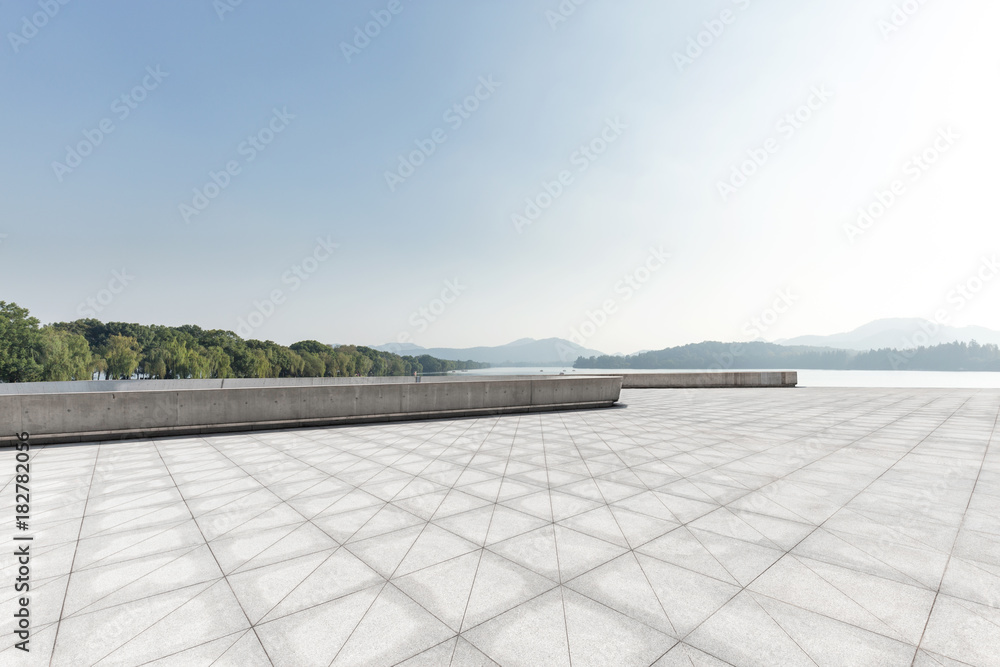 empty marble floor with beautiful lake in blue sky