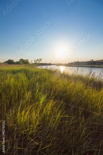 Landscape at sunset on the river in summer