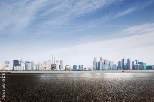 empty asphalt road with modern cityscape