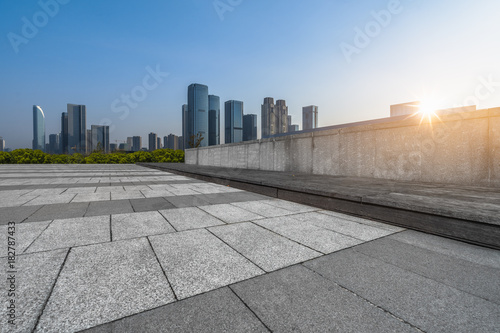 empty brick floor with cityscape and skyline. © hallojulie