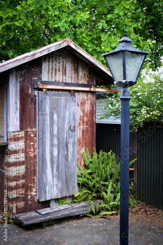 Old rust garden Shed and lamp post in garden area