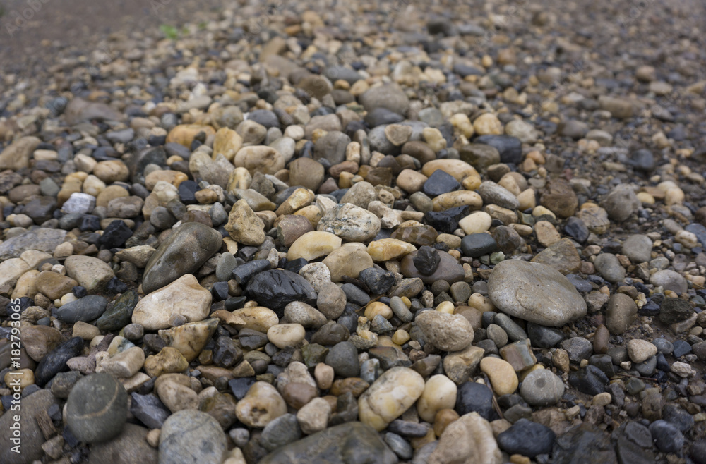 Detail of surface texture with small pebble rock on dirty ground. Detail of surface texture with small pebble rock on dirty ground.