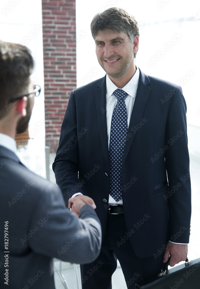 Handshake of a businessman and a lawyer in the office