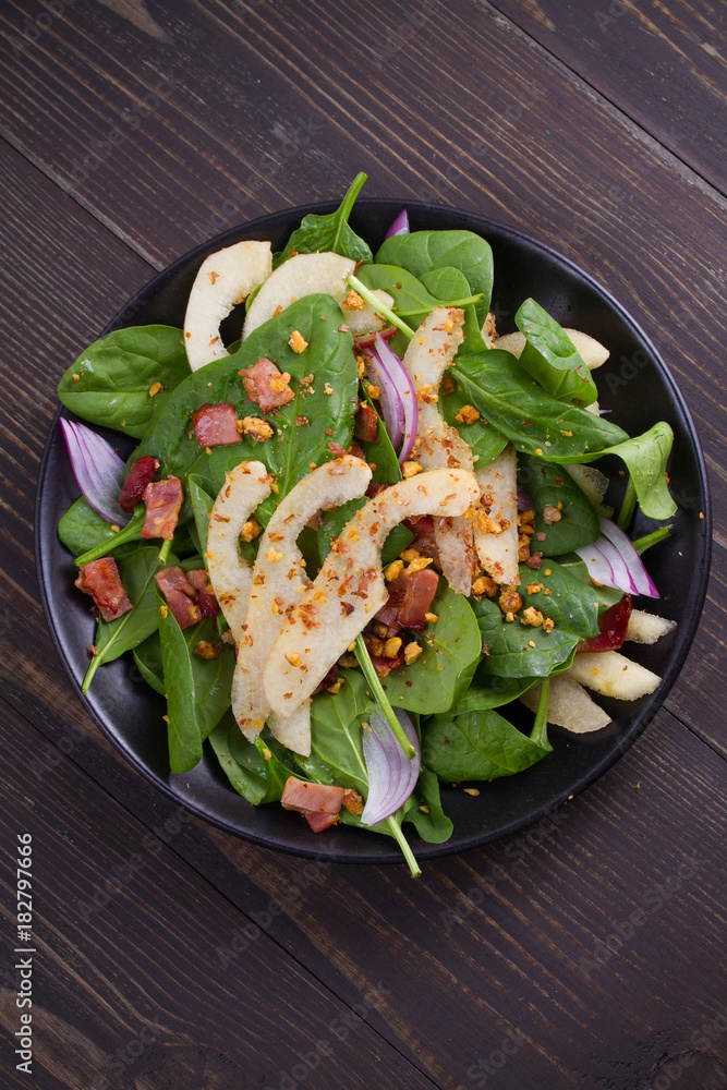 Warm spinach pear and bacon salad. View from above, top