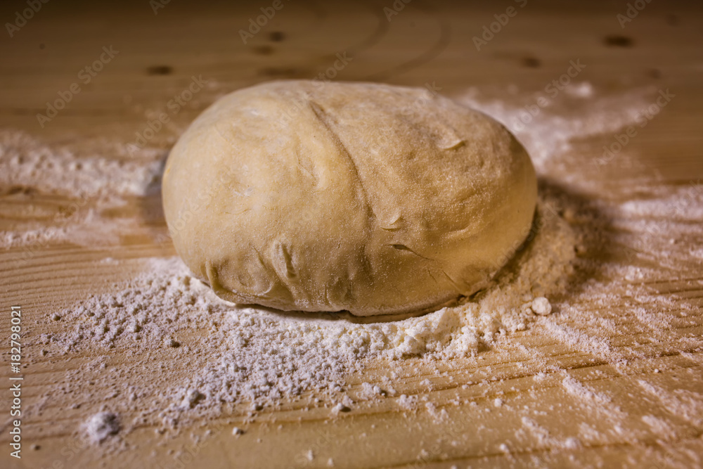 The piece of dough on the table The piece of dough on the table