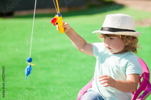 Adorable little girl fishing.