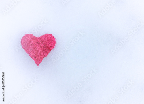 Pink heart on the snow.