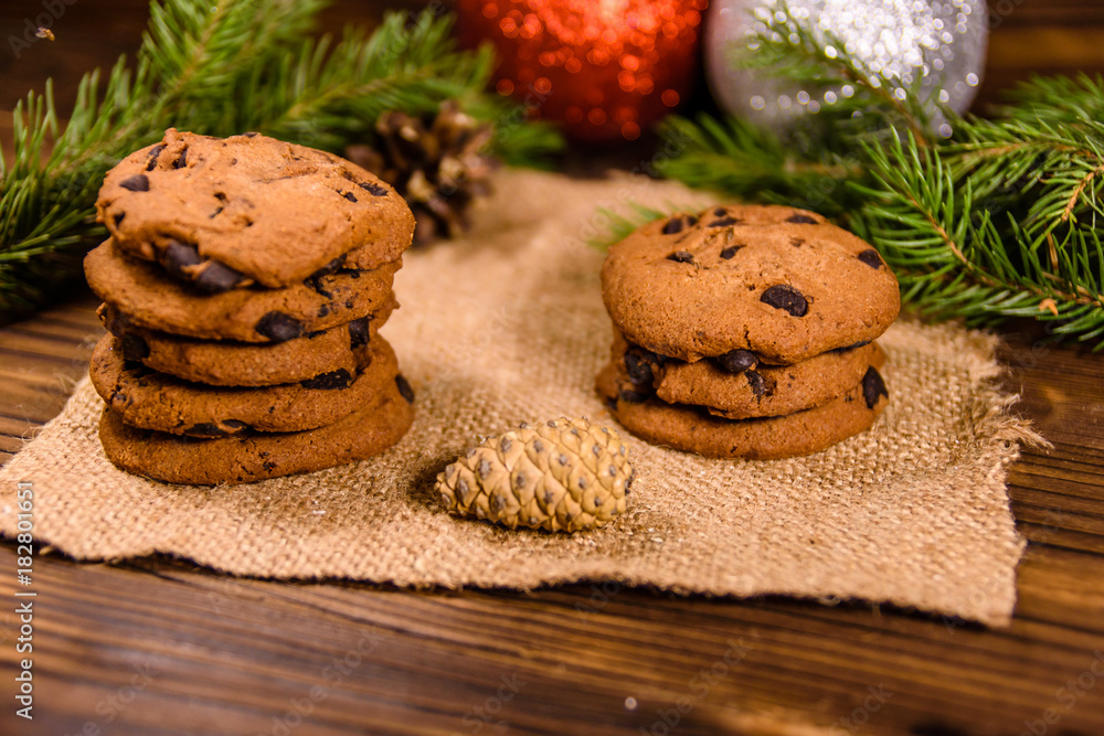 Chocolate chip cookies and christmas decorations on a wooden table Chocolate chip cookies and christmas decorations on a wooden table