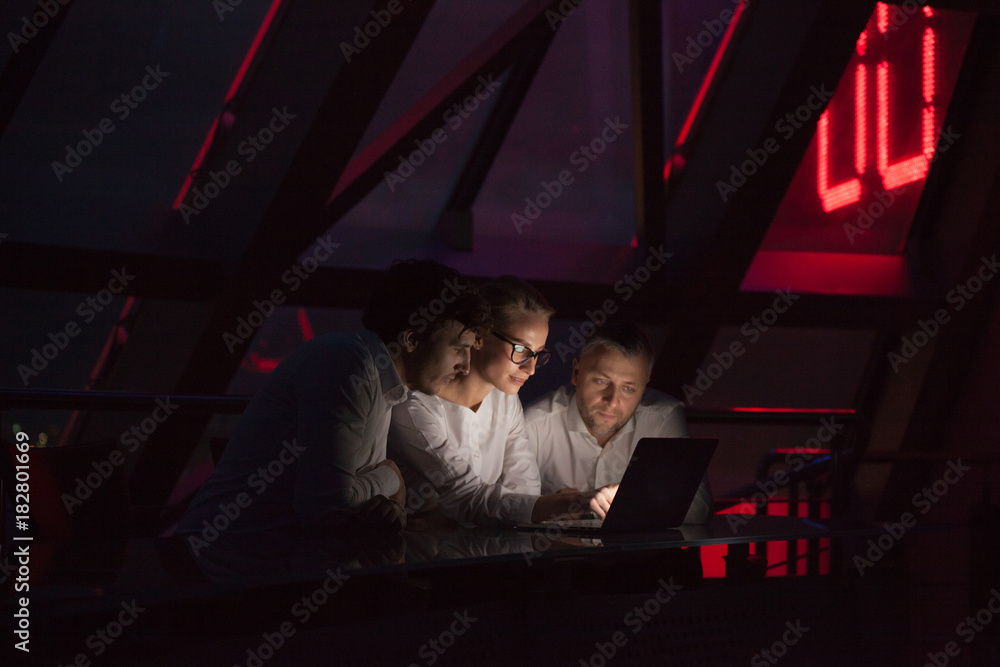 Group of business people working in a night office.