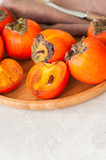 Plate of fresh and ripe persimmons. Close up.