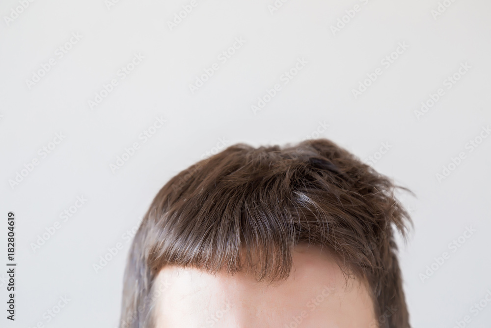 Man's dry brown hair before and after hair brushing with comb on the gray background. A little bit funny. Cares about a healthy and clean hair. Beauty salon concept. Man's dry brown hair before and after hair brushing with comb on the gray background. A little bit funny. Cares about a healthy and clean hair. Beauty salon concept.