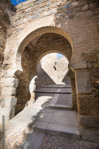 pedestrian access to Toledo city through Alcantara Gate, landmark and monument from ancient arab age, in Spain, Europe 