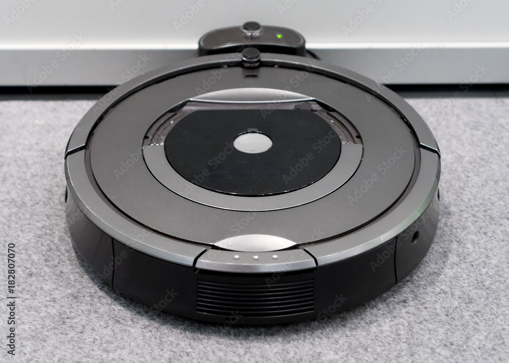 Robotic vacuum cleaner recharging charging on the base. Robotic vacuum cleaner recharging charging on the base.