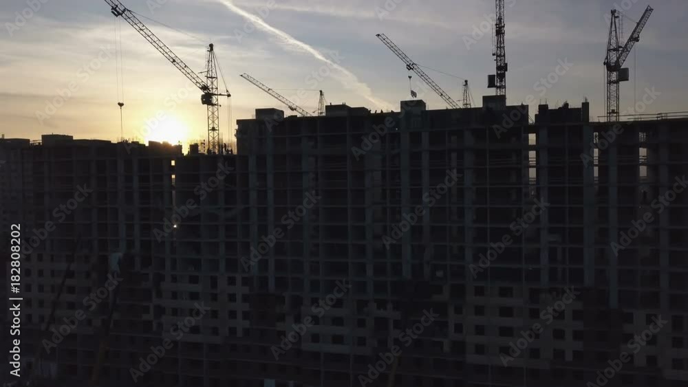 Aerial view of modern city construction and development at sunset Aerial view of modern city construction and development at sunset