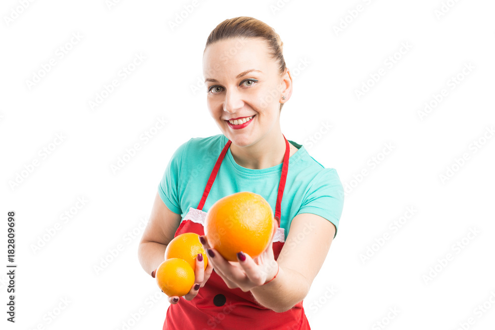 Hypermarket or supermarket employee holding fresh natural oranges Hypermarket or supermarket employee holding fresh natural oranges