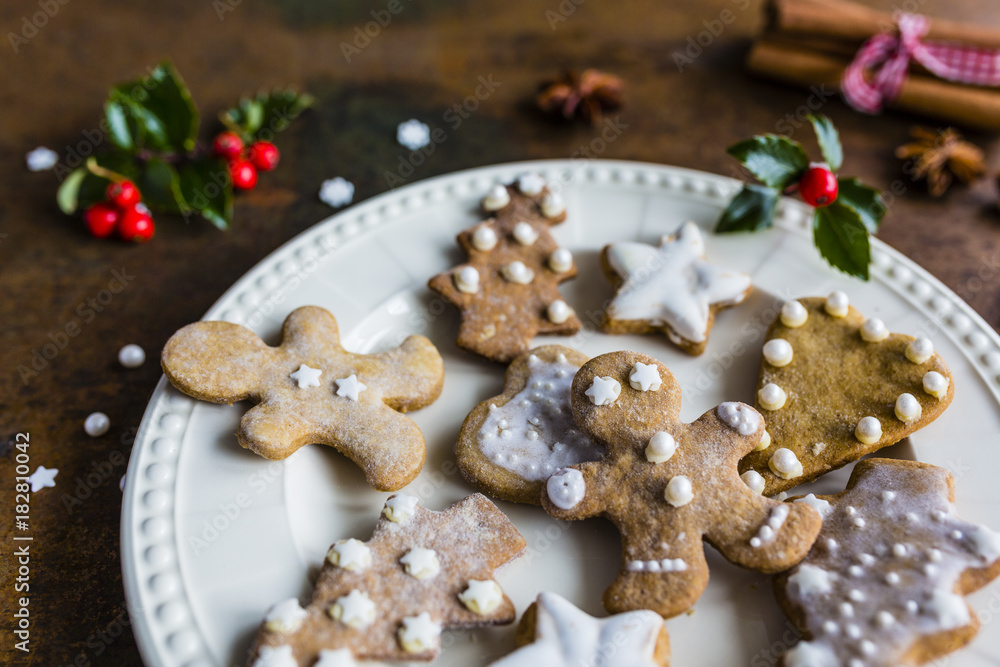 Homemade Christmas gingerbread cookies served on plate and vintage background. Homemade Christmas gingerbread cookies served on plate and vintage background.