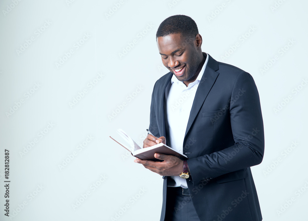 African American business man making a note in his notebook African American business man making a note in his notebook
