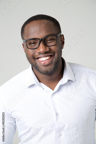 Portrait of afro american man with glasses. Smiling face of a young man. © A Stock Studio