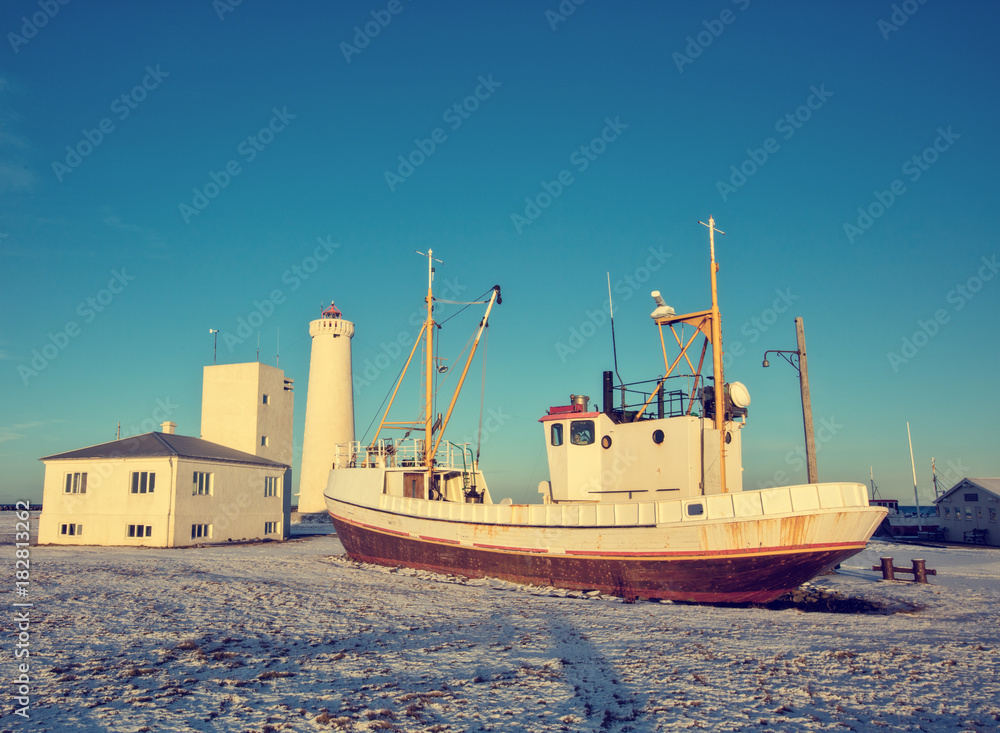 Fototapeta premium Old fisherman boat in Iceland in grunge colored design