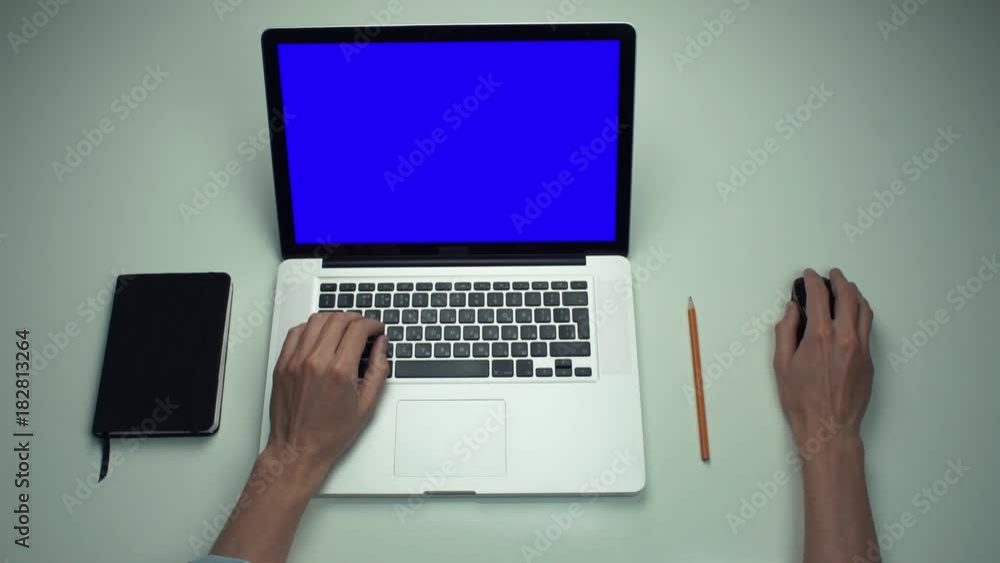 Top view male hands using optical mouse of laptop computer with green screen Top view male hands using optical mouse of laptop computer with green screen
