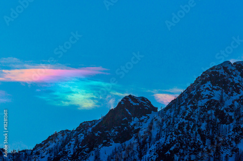 cloud with natural circumhorizontal arc and mountain peak in winter photo