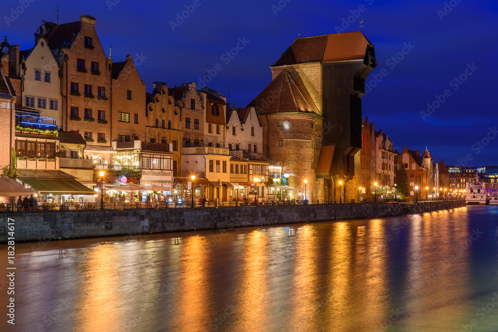 Famous old port crane of Gdansk and Motlawa river at night.  Poland, Europe.